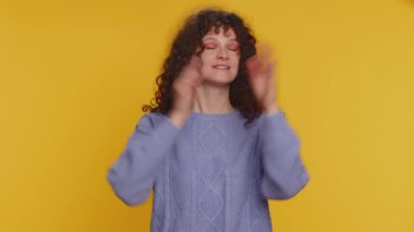 Dont want to hear and listen. Frustrated annoyed irritated curly haired woman covering ears gesturing No, avoiding advice ignoring unpleasant noise loud voices. Young girl on studio yellow background