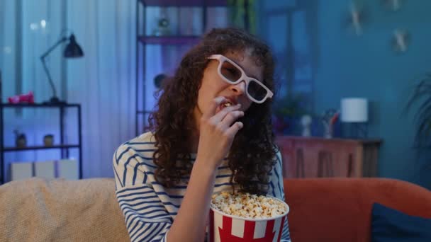 Excited Young Woman Sits Sofa Eating Popcorn Snacks Watching Interesting — Vídeos de Stock