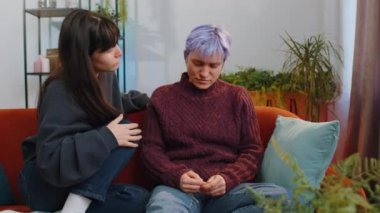 Two lesbian women family couple at home. Woman tries to calm, sympathize and hug her wife while she tired regret upset worry on bad news career crisis stress relief. Aborted pregnancy. Compassion