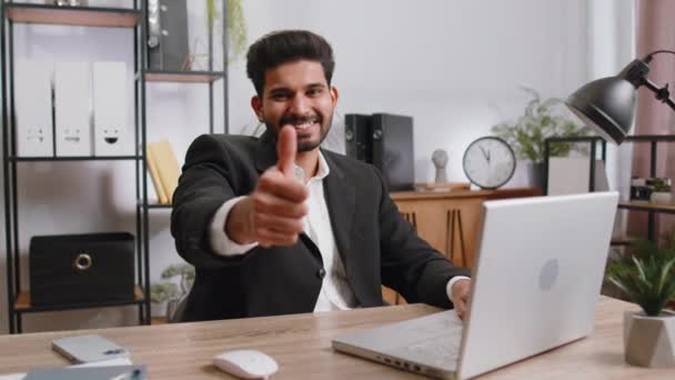 Happy Young Indian Businessman Guy Working Laptop Looking Approvingly Camera — Stockvideo