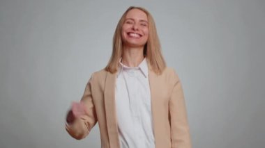 Happy joyful office business woman shouting, raising fists in gesture I did it, celebrating success, winning, birthday, lottery jackpot goal achievemen, good news. Adult girl on gray studio background