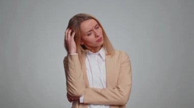 I dont know what to say. Confused businesswoman feeling embarrassed about ambiguous question, having doubts, no idea, being clueless and uncertain. Female girl in formal suit. Woman on gray background