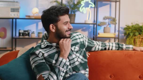Portrait Happy Calm Indian Man Home Couch Smiling Friendly Glad — Vídeos de Stock