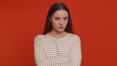 Dissatisfied pretty nervous woman asking reason of failure, expressing disbelief irritation, feeling bored, disappointed in result, bad news. Young adult girl isolated alone on red studio background