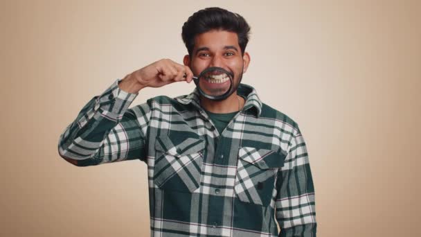 Indian Man Holding Magnifier Glass Healthy White Teeth Looking Camera — Stock video