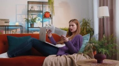 Stressed woman at home room looking at unpaid bank debt bills, doing paperwork, planning budget, calculate finances mortgage payments. Portrait of girl throws paper bills lying on couch. Lifestyles