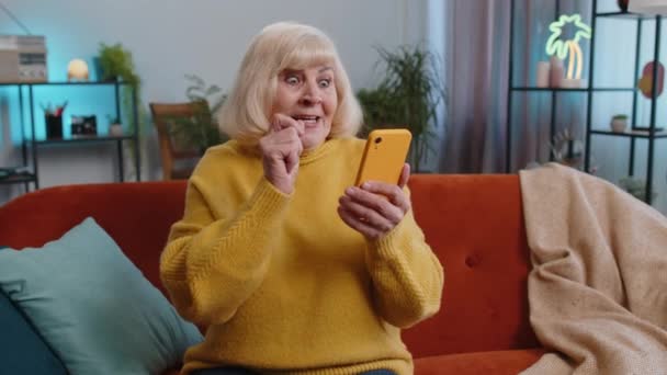 Happy Senior Grandmother Use Mobile Smartphone Typing Browsing Say Wow — Stock Video