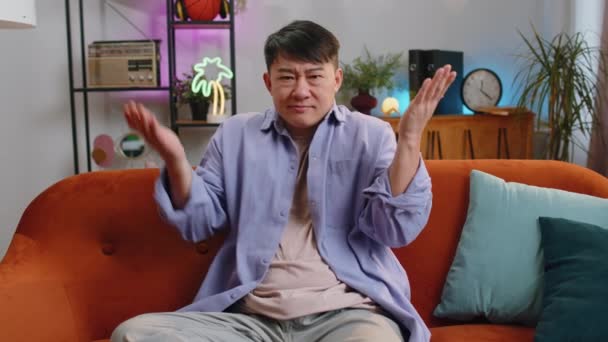 모르겠어 스러운 아시아인잘생긴 남자는 모르는 집에서 아무것도 모르는 부끄러워하고 있습니다 — 비디오