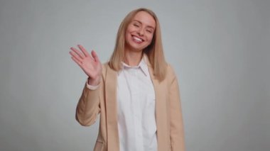 Come here, join us. Welcome. Secretary office woman showing inviting gesture with hands, ask to join, beckoning to coming, gesturing hello or goodbye. Business girl isolated on gray studio background