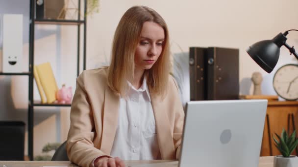 stock video Young businesswoman working on laptop computer shakes finger and saying No be careful scolding and giving advice to avoid danger mistake disapproval sign at home office. Confident freelancer woman