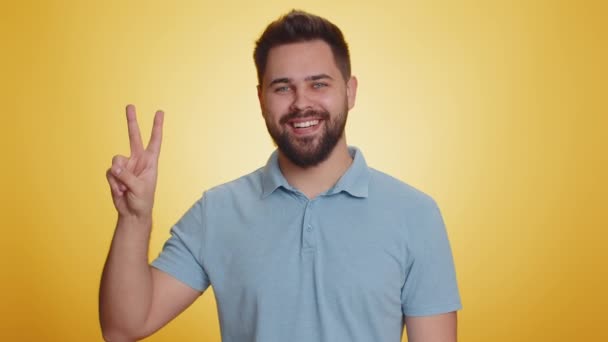 Young Caucasian Man Showing Victory Sign Hoping Success Win Doing — Stock Video