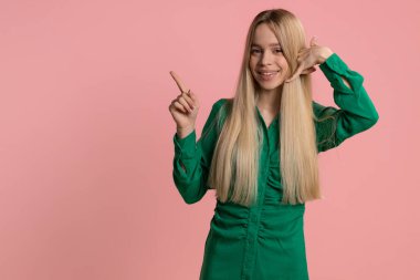 Bizi arayın, bu da iletişim numarası. Beyaz elbiseli güzel bir kadın kameraya bakıp 