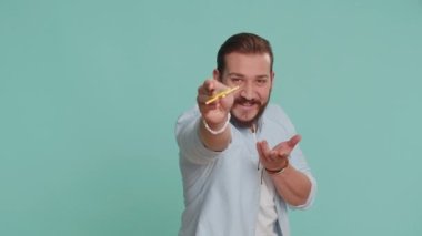 Sihirbaz sihirbaz sihirli değnekle el kol hareketi yapıyor, dileği gerçekleştiriyor, sihirbaz büyüsü yapıyor, tatil indirimi yapıyor. Yakışıklı Lübnanlı adam mavi stüdyo arka planında izole edilmiş.
