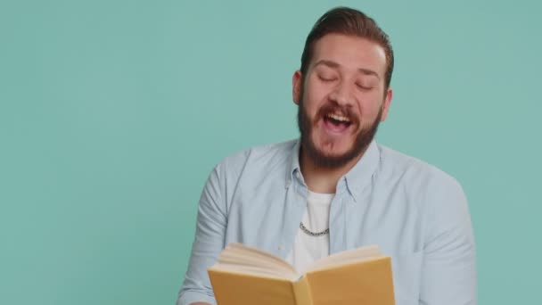 Happy Lebanese Man Reading Funny Interesting Fairytale Book Leisure Hobby — стоковое видео