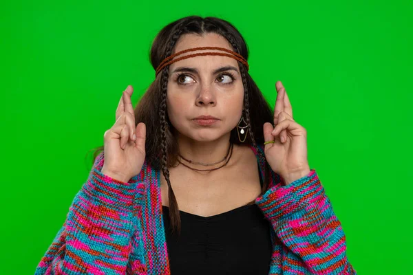 Young woman crossed fingers looking at camera asking for good luck news, wishing good education exam results dreaming about win victory in lottery jackpot. Girl isolated on chroma key, green screen