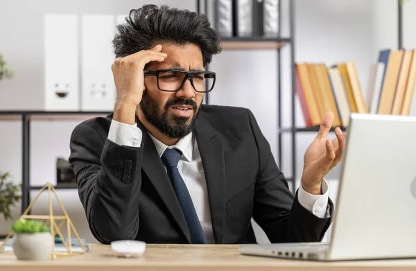 stock image Indian businessman programmer software developer working on laptop loses becoming surprised by bad news results, fortune loss fail at home office. Deadline, bankruptcy. Freelancer man