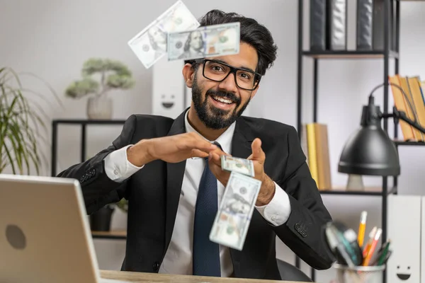Cheerful Rich Young Indian Businessman Working Laptop Wasting Throwing Money — Stok fotoğraf