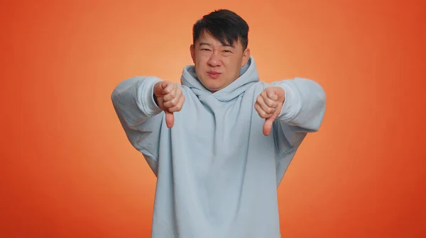 Dislike Upset Unhappy Asian Man Hoodie Showing Thumbs Sign Gesture — Fotografia de Stock