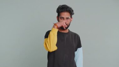 Gözüm üzerinde. Kendine güveni tam genç Hintli adam, kameraya ve gözlerine bakıyor, jest yapışını, birini gözetlediğini görüyorum. Yakışıklı, sakallı Hintli adam. Gri stüdyo arka planında tek başına.