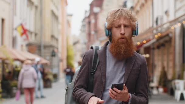 Glücklich Entspannter Junger Stilvoller Rocker Mit Kabellosen Kopfhörern Der Freien — Stockvideo