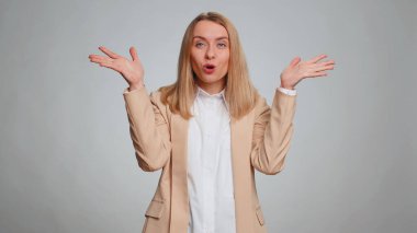 Oh my God, Wow. Excited amazed winner office woman raising hands in surprise looking at camera with big eyes, shocked by sudden victory. Sincere business girl isolated alone on gray studio background