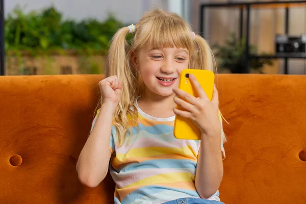 Young Blonde Child Kid Girl Use Mobile Smartphone Typing Playing — стоковое фото