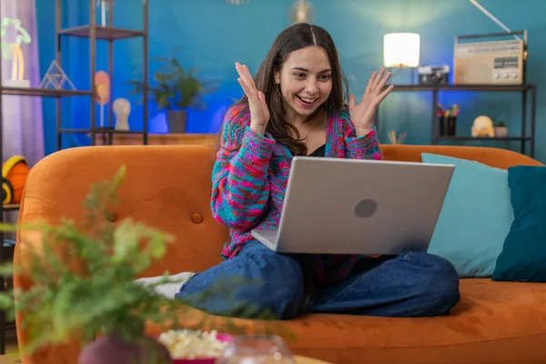 stock image Surprised Caucasian woman using laptop computer, receive mail good news message, shocked by sudden victory celebrate lottery jackpot win purchases online shopping at home apartment on sofa. Lifestyles