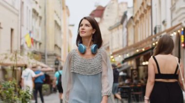 Avrupa şehir sokaklarında yaz günlerinde gezen güzel genç kadın turistin portresi. Gezgin kız gülümsüyor ve dışarıda eğleniyor. Kasaba yaşam tarzları, tatil