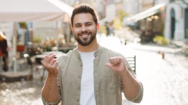 Neşeli, zengin, sakallı genç adam el hareketleriyle etrafa para saçıyor, daha fazla bahşiş veriyor, büyük kar ediyor, piyango kazanıyor, paylaşıyor, dışarıda kutluyor. Şehir caddesinde duran beyaz adam.