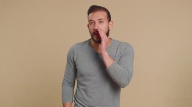 Sırlarımı sakla, sessiz ol. Lübnanlı adam el ele tutuşup dedikoduları fısıldıyor. Dedikoduları paylaşıyor. Orta Doğulu bir adam pembe arka planda, kapalı alanda ilginç, gizli bir hikaye anlatıyor.
