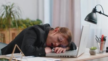 Sıkıcı, uykulu, Kafkasyalı iş kadını. Dizüstü bilgisayarda çalışıyor. El üstünde esniyor ve ofiste uyuyakalıyor. Yorgun, serbest çalışan, işkolik bir kız. İstihdam, meslek, işsiz