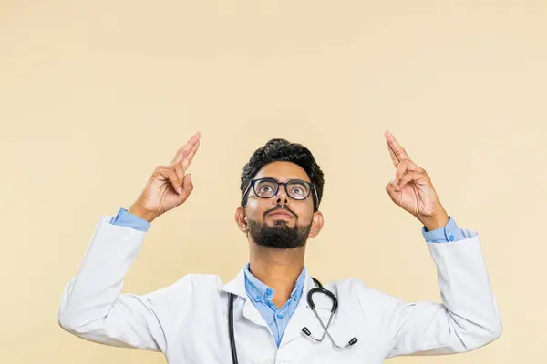 Indian Young Doctor Cardiologist Man Show Thumbs Pointing Overhead Empty — Stock Photo, Image