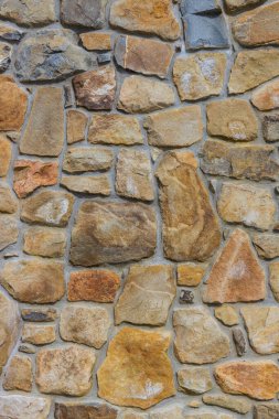 Taş duvar dokusu düz zemin, arka plan doğal sarı turuncu kahverengi tuğla, dış seramik duvar fayansları, dizayn iç şömine, rastgele döşeme döşemeleri, kaldırım bahçesi, park alanı.