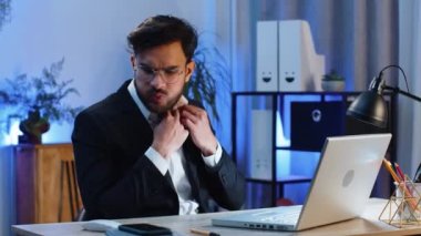 Stresli Hintli işadamı, modern ofis çalışma masasında çalışırken göğsünde kalp krizi geçirme riski bulunan gerilimden muzdarip. Resmi takım elbiseli erkek Hindu.