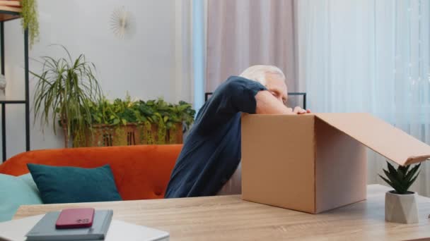 Happy Senior Man Unpacking Delivery Parcel Com Fones Ouvido Casa — Vídeo de Stock