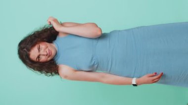 You are crazy, out of mind. Displeased woman pointing at camera, show stupid gesture finger near head, blaming some idiot for dumb insane plan idea, senseless talk. Girl on blue background. Vertical