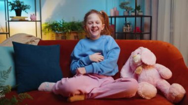 Çocukluk çağındaki bir kız, saçma sapan anekdotlar, komik şakalar duyduktan sonra gülerek, kaygısızca eğleniyor, evde olumlu insanların yaşam tarzlarını öğreniyor. Genç bayan çocuk akşam odasında, kanepede.