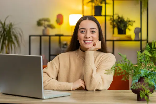 Portrait of happy calm pretty woman at home table smiling friendly glad expression looking dreaming resting, relaxation feel satisfied good news celebrate win. Caucasian young girl in office room