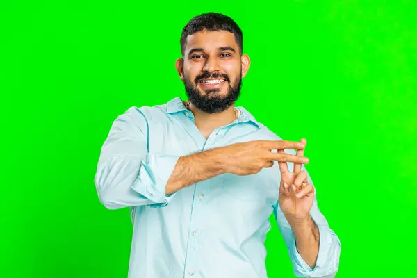 Hashtag. Indian man showing cross symbol with fingers, likes tagged message, popular viral social media content, sign to follow internet online trends. Arabian guy on green chroma key background