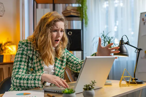 Frustrated business woman having software problems with laptop, angry woman get nervous seeing error or mistake notification at computer screen, mad employee experience virus attack or app malfunction