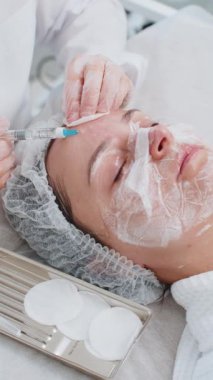 Güzellik anti-aging enjeksiyon biyo-evitalizasyon yüz yüze mezoterapi. Kozmetik doktoru genç bir kızın derisine hiyalüronik enjeksiyon yapıyor. Klinikte kaldırma işlemi