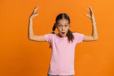 Şok olmuş gibi görünen genç kız çocuğu şaşırdı. Beyin patlaması sonucu oluşan kafa patlaması çözümüne şaşırdı. Turuncu arka planda şok geçirmiş genç çocuklar var.