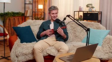 Evdeki genç blogcu neşeli bir şekilde kanepede ukulele çalar, duygusal ve eğlenceli bir şekilde şarkı söyler. Beyaz adam stüdyo mikrofonunda müzik kaydediyor, yaratıcılık, tutku, yetenek ve stil ifade ediyor..