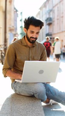 İnternette uzaktan bilgisayarla çalışan Hintli serbest çalışan bir adam ara verildiğinde şehir caddesinde oturup web sitesinde sohbet ediyor. Defter ekranına bakan adam film izleyen mesajlar gönderiyor. Dikey
