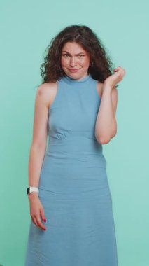 You are crazy, out of mind. Displeased woman pointing at camera, show stupid gesture finger near head, blaming some idiot for dumb insane plan idea, senseless talk. Girl on blue background. Vertical