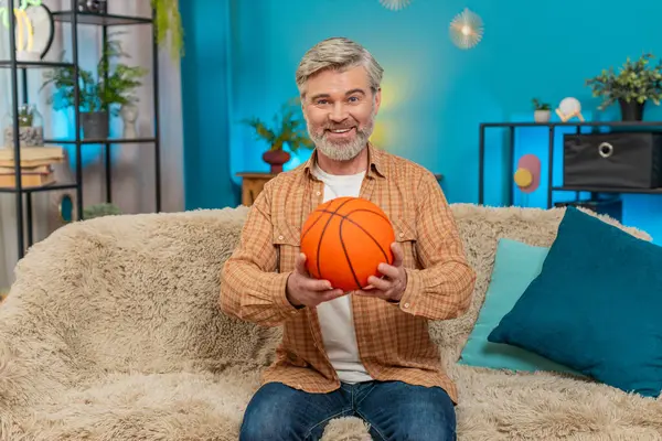 Beyaz, olgun bir adam evinde rahat bir koltukta oturuyor, elinde bir basketbol topu tutuyor ve fırlatıyor. Orta yaşlı adam topu parmağında döndürüyor, hafif hissediyor, neşeli anın tadını çıkarıyor. Oyun rahatlama mutluluğunun neşesi