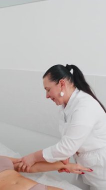 Kozmetik uzmanı kadın masaj uzmanı ellerini ovuşturuyor. Kozmetik, el bakımı, kaplıca, güzellik konsepti. Fiziksel Güzellik Uygulamasında kadın istemci soyma oturumu