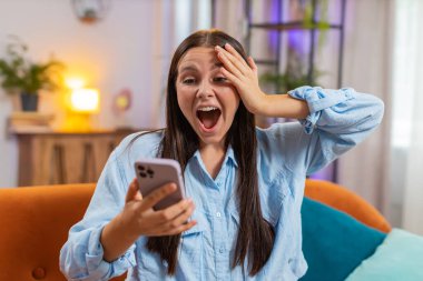 Şaşırmış bir kadın cep telefonu daktilo kullanarak 