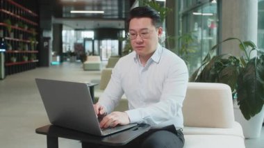 Hoşlanmamak. Ofis lobisinde dizüstü bilgisayarla çalışan üzgün bir işadamı işaret dilini gösteriyor, hoşnutsuzluğunu, memnuniyetsizliğini ve kötü işini ifade ediyor. Otel odasında hoşnutsuz ciddi bir adam var..