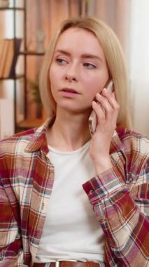 Genç yetişkin bir kadın, koltukta oturup reddederek akıllı telefondan rahatsız edici aramalar yapmayı reddediyor. Kız, spam veya dolandırıcı arayana hüsranla tepki göstererek, vücut diline olan anlaşmazlığını dile getiriyor.